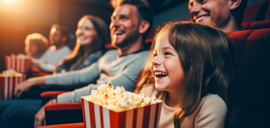 A family at the cinema eating popcorn